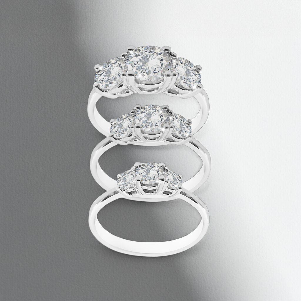 Silver ring with multiple diamond-like stones on a gray background