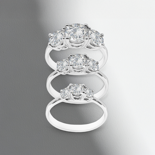 Silver ring with multiple diamond-like stones on a gray background
