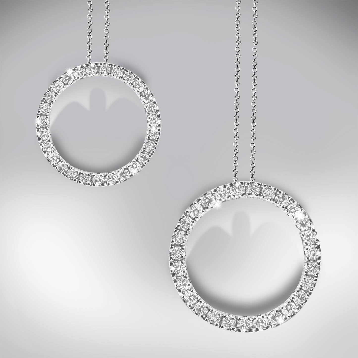 Two diamond circle pendants on a gray background