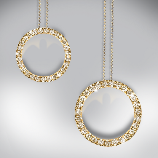 Two gold circle pendants with diamond accents on a gray background