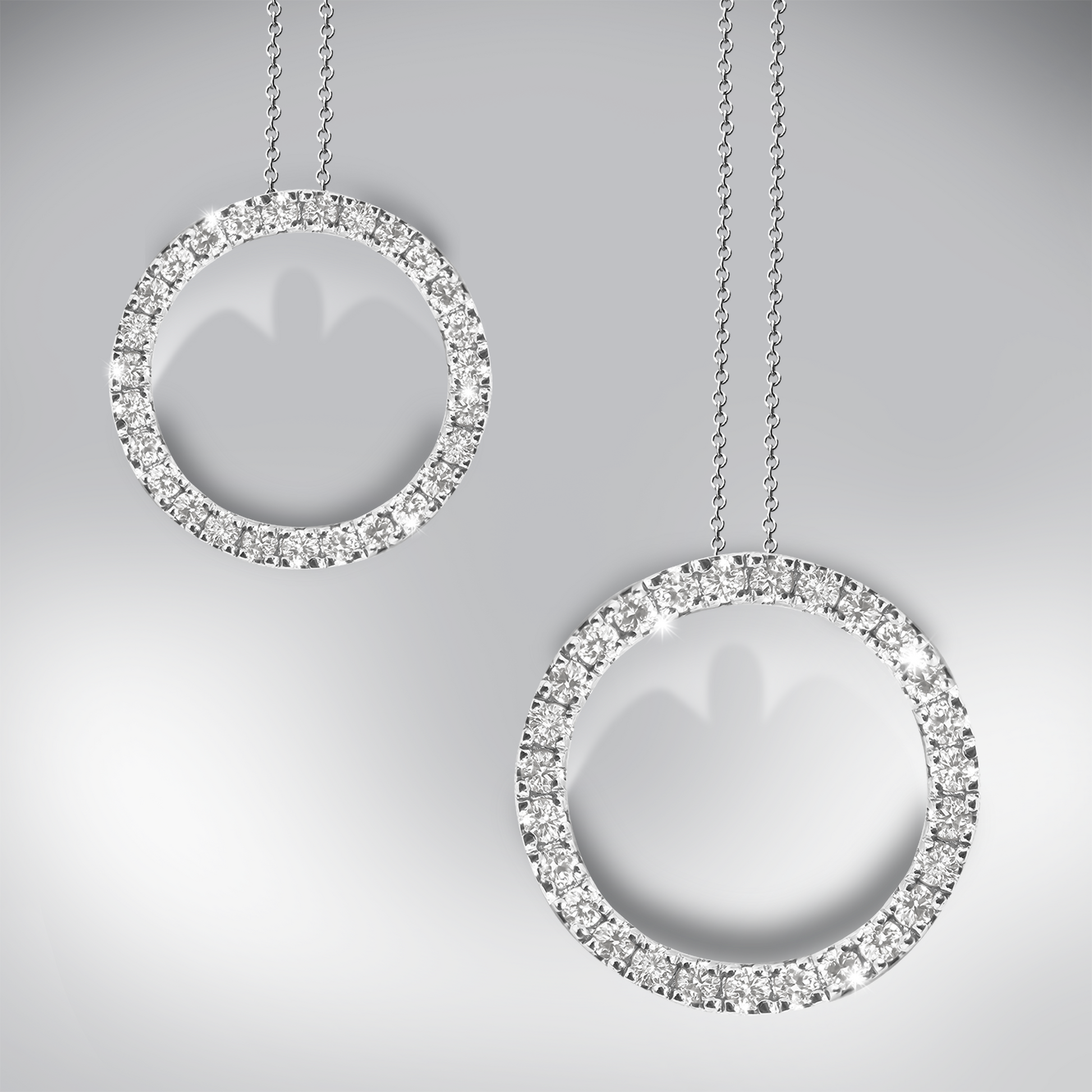 Two diamond circle pendants on a gray background