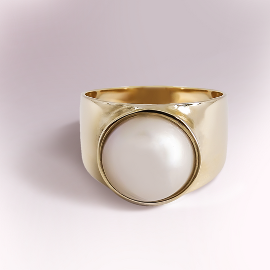 Single Broad Mabe pearl set in a bezel ring in 9ct Yellow Gold